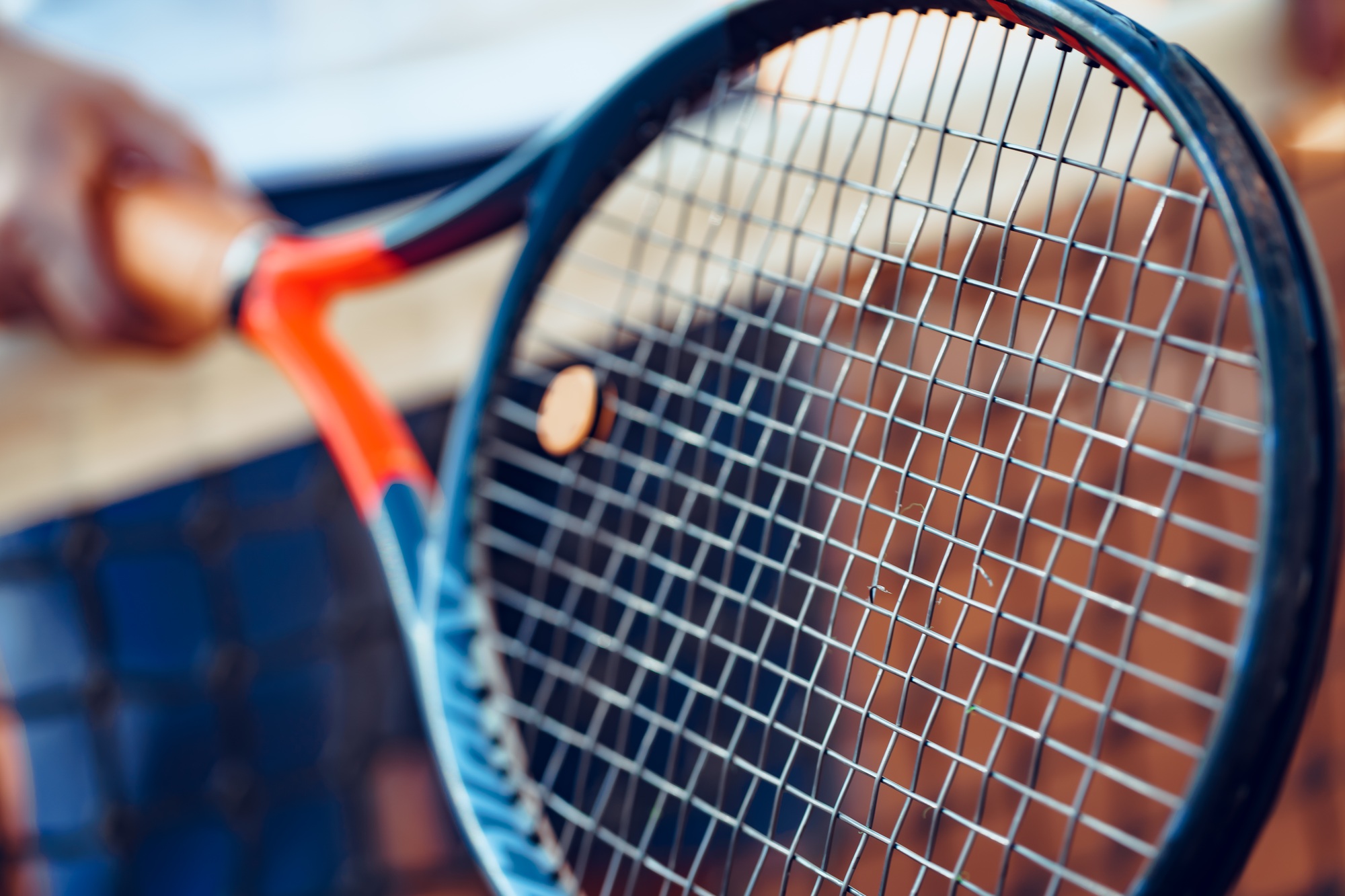 Tennis racket and tennis net on tennis court