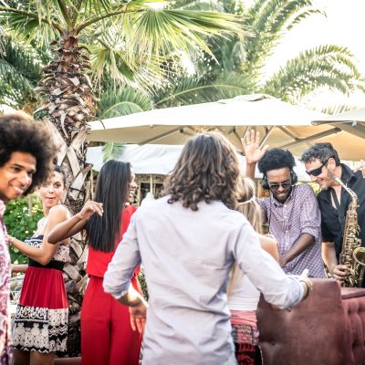 Friends dancing in a lounge bar, with dj set