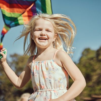 Running child, portrait and kite playing in park, nature garden or house backyard on holiday vacati